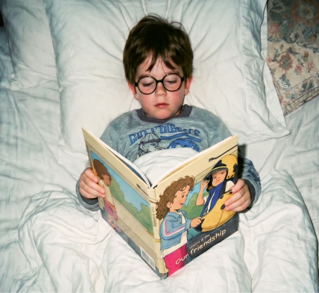 A boy reading his personalized nopad book in bed